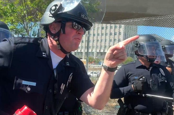 An officer tells press they need to leave or be subject to arrest at an immigration protest in Los Angeles, California, on April 11, 2026.