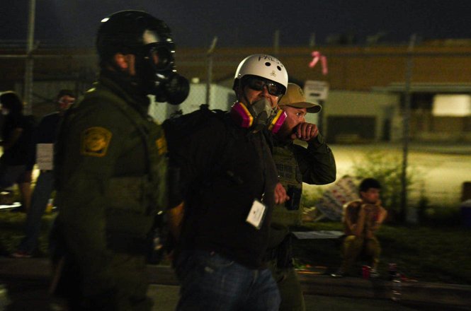 Steve Held, a journalist with Unraveled Press, at center, is taken into custody while reporting on a U.S. Immigration and Customs Enforcement protest in Broadview, Illinois, on Sept. 27, 2025.