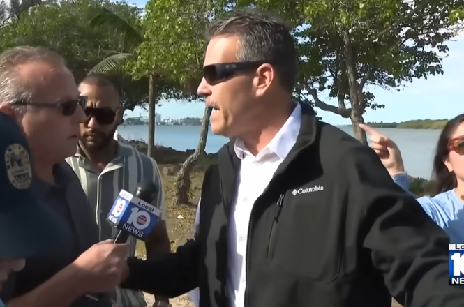 WPLG television reporter Jeff Weinsier, at left holding microphone, was pushed by a plainclothes sheriff’s deputy while trying to ask Miami-Dade County Mayor Daniella Levine Cava a question on April 11, 2026, in Miami Beach, Florida