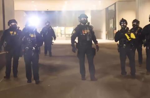 Federal officers advance on journalists and protesters in front of the Federal Building in Eugene, Oregon, on Jan. 27, 2026