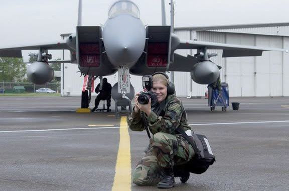 Trisha Brownlee, pictured above during her service as a military photographer, was arrested by police on June 11, 2026, in Hardwick Township, New Jersey, while interviewing two individuals observing immigration agents. She has been in jail since.