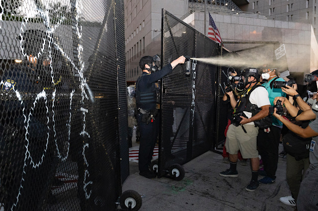 A Department of Homeland Security agent pepper-sprays a group of journalists covering a protest in Los Angeles, California, on Sept. 1, 2025.