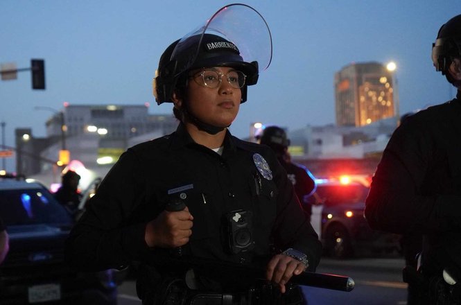 An officer stands with baton at the ready as police formed a kettle around press and protesters in Los Angeles, California, on May 1, 2026. L.A. Taco reporter Lexis-Olivier Ray was detained for about 15 minutes before being released without charges.